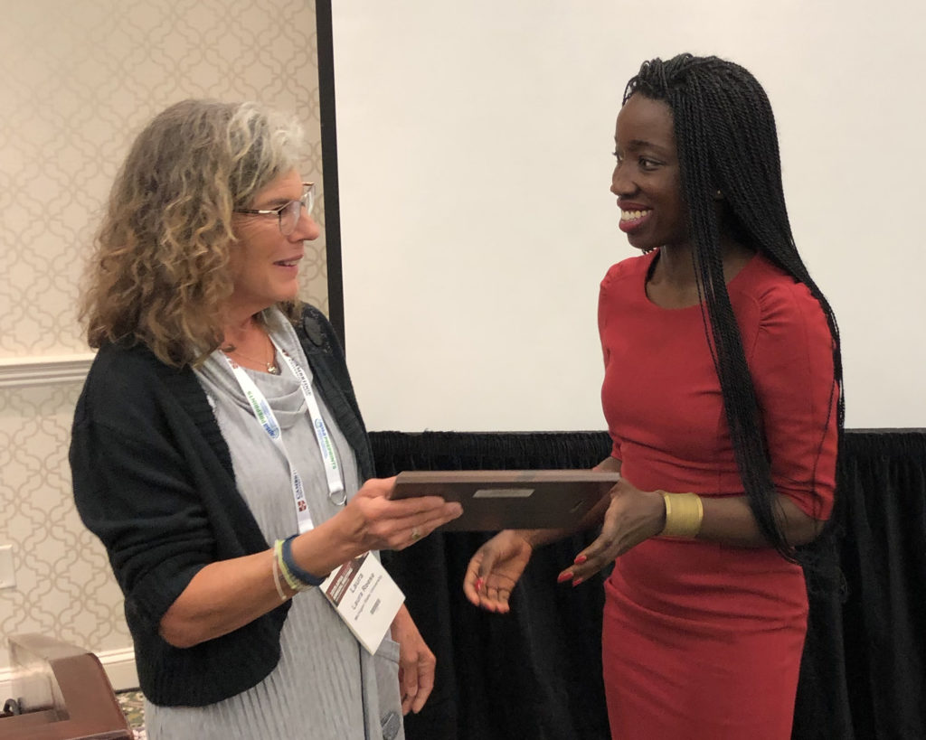 Section president Laura Reese presents the Clarence Stone Scholar Award to Sally Nuamah at the 2019 APSA annual conference.